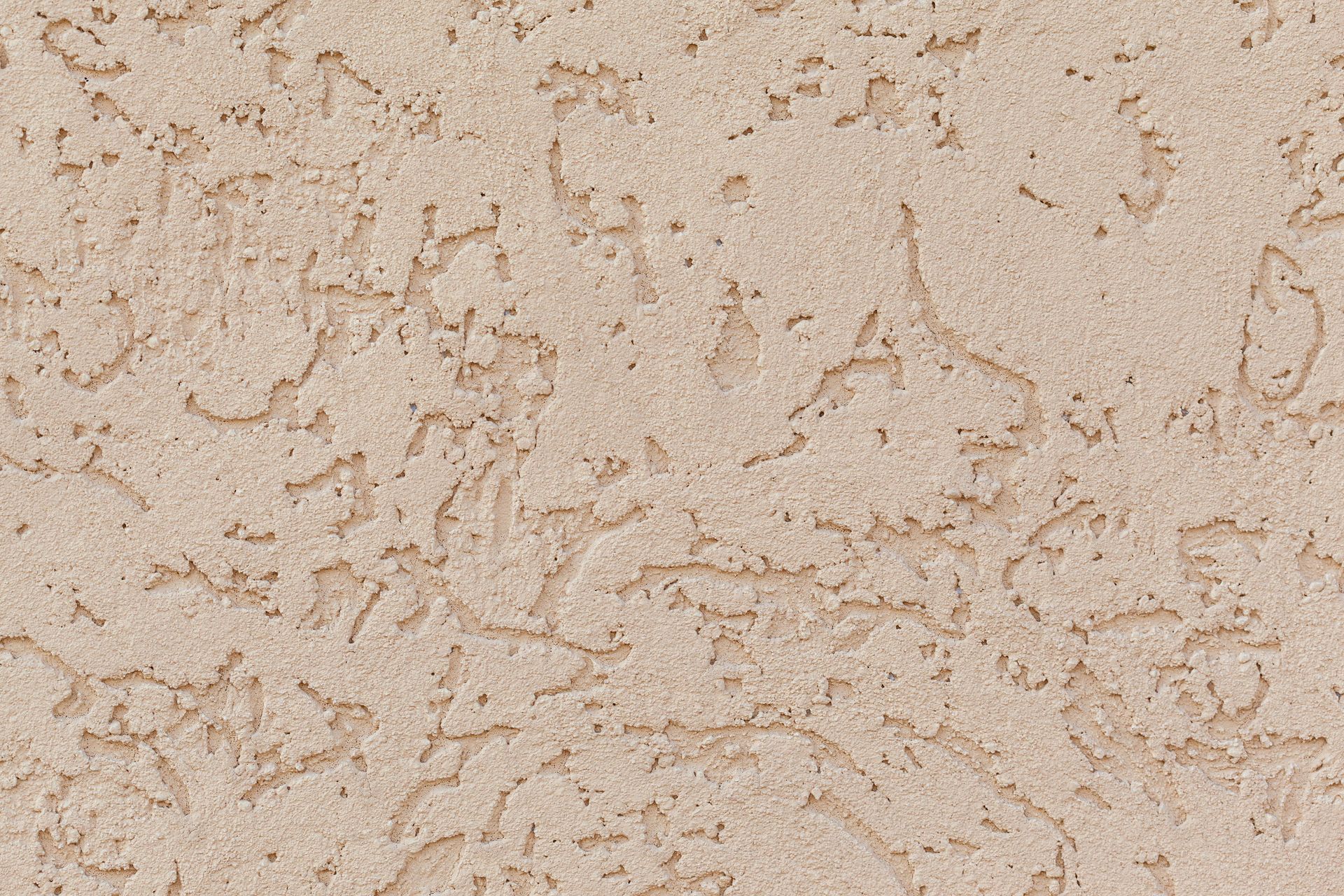 Background of cracked plaster surface with rough texture of light beige color on wall